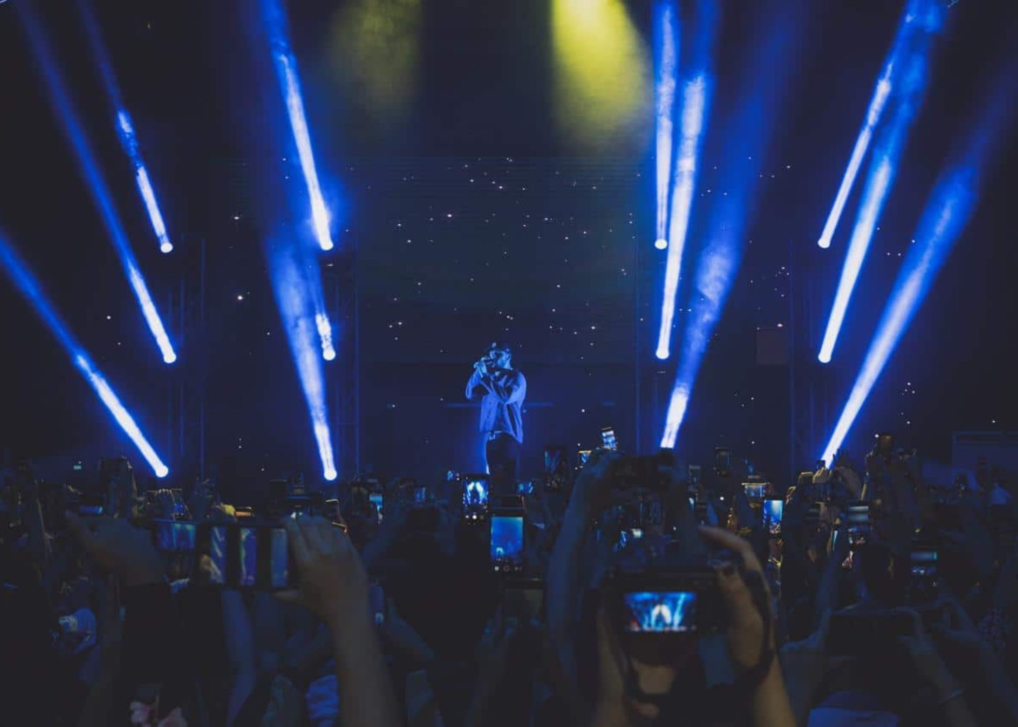 A distant picture showing Bazzi performing in front of the people