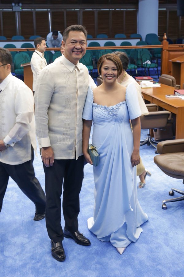 Nancy Binay standing in a light blue Filipiniana dress